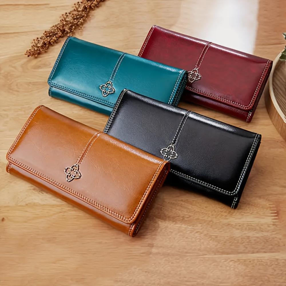Cartera larga de piel Nicole de Vega Madrid, en color marrón, con cierre y múltiples compartimentos visible desde el lateral.