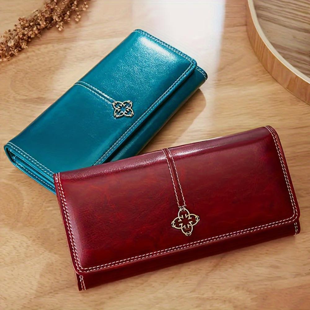Cartera larga de piel Nicole de Vega Madrid, con cierre y diseño elegante en color marrón.