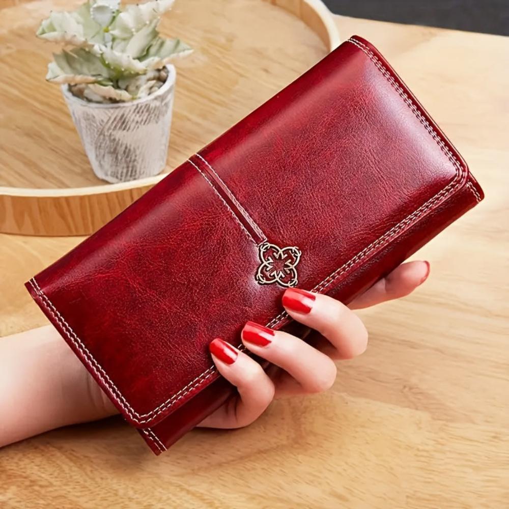 Cartera larga de piel Nicole de Vega Madrid, en color marrón, con múltiples compartimentos y diseño elegante.