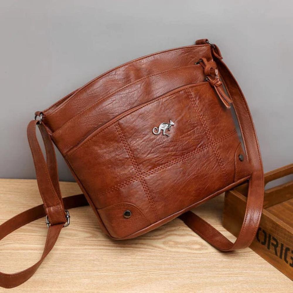Bolso de hombro de piel Madeleine de Vega Madrid con diseño elegante y asas ajustables, en color negro.
