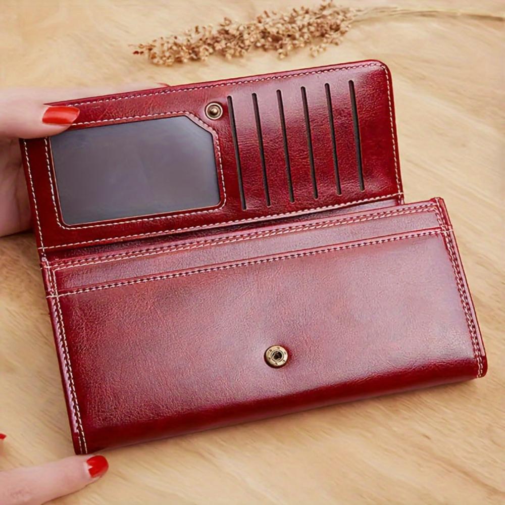 Cartera larga de piel Nicole de Vega Madrid, elegante y espaciosa, con cierre y detalles en acabado suave y de alta calidad.