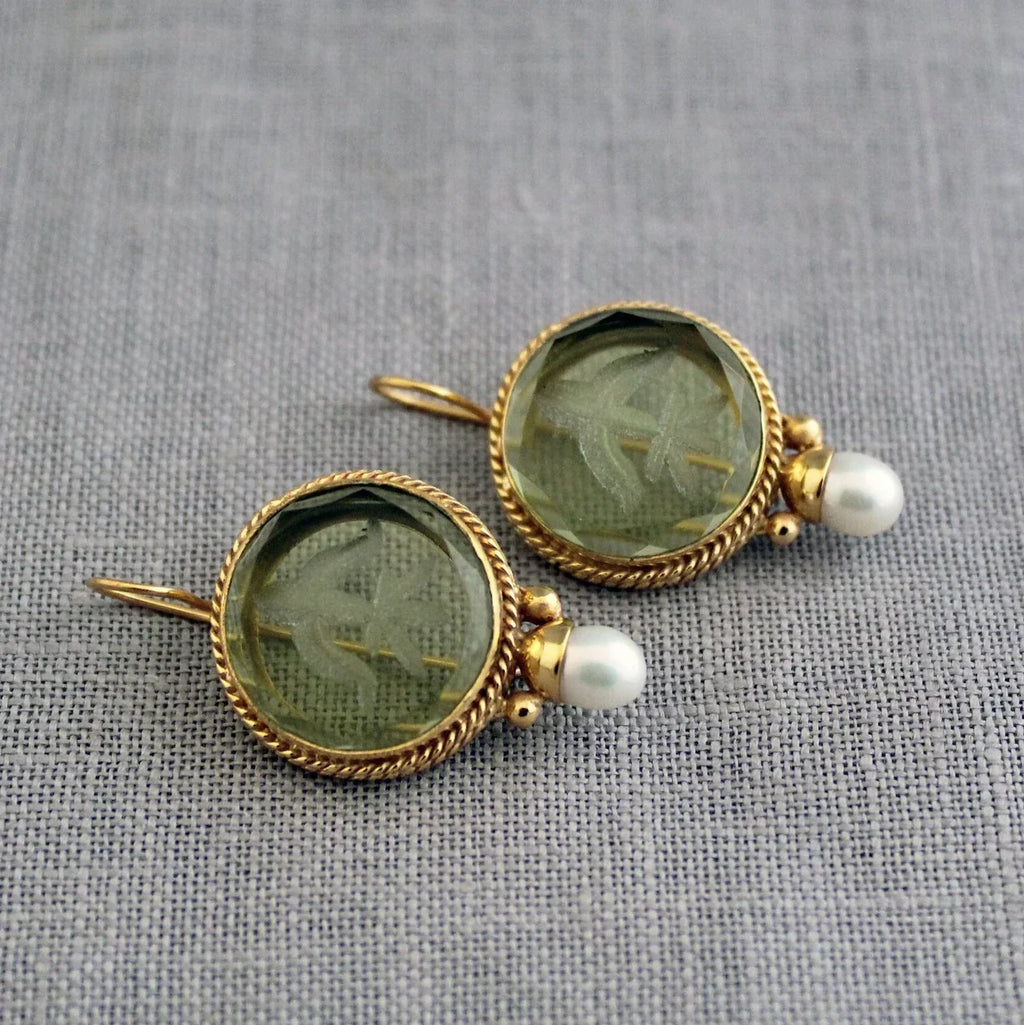 Pendientes premium Penelope de Vega Madrid, diseño elegante con detalles metálicos y acabado brillante sobre fondo neutro.