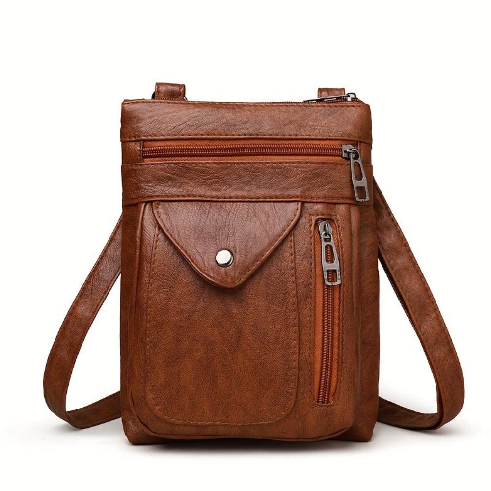 Bolso bandolera de piel Danielle de Vega Madrid, con asa ajustable y diseño elegante en color negro.