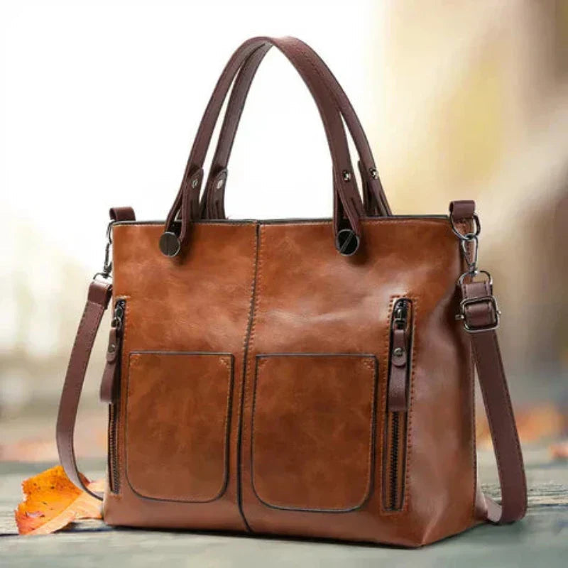 Bolso de piel Sydney de Vega Madrid, diseño versátil con asas y compartimentos visibles, en color negro elegante.
