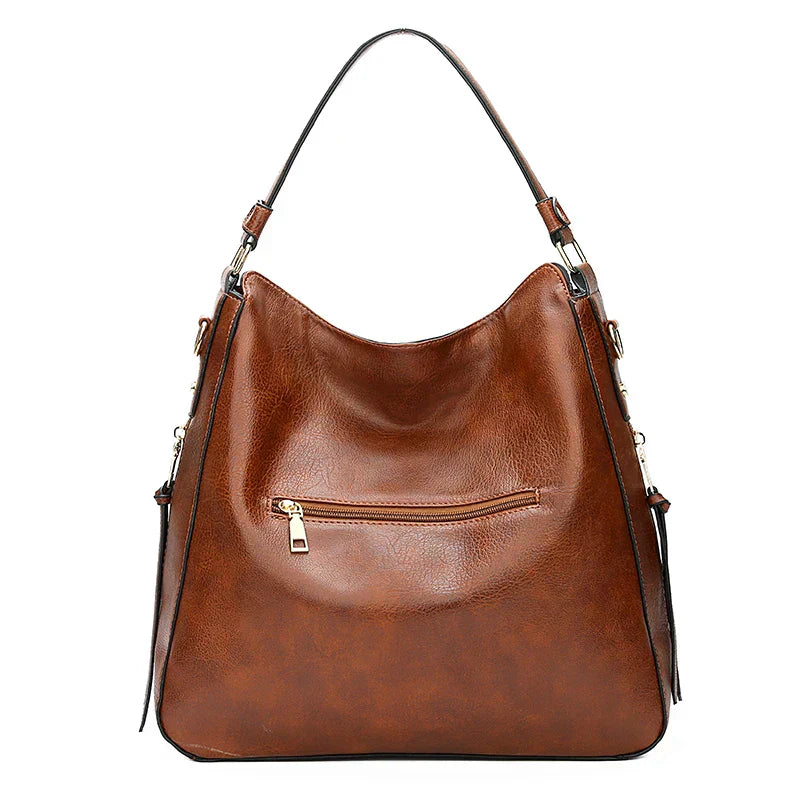 Bolso de hombro de piel Morgan de Vega Madrid, diseño clásico y elegante en tono marrón, con asa ajustable y detalles en piel.