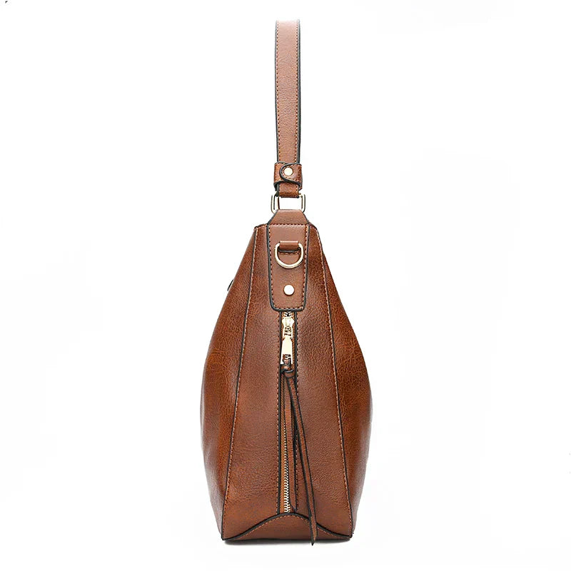Bolso de hombro de piel Morgan de Vega Madrid, diseño clásico con asa de cuero y acabado elegante en color neutro.