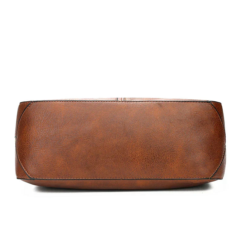 Bolso de hombro de piel Morgan Vega Madrid, con diseño clásico y detalles en textura suave, en color marrón oscuro.