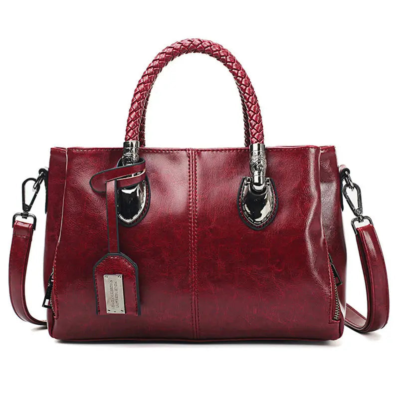Bolso de piel Cassandra de Vega Madrid con asas cortas y diseño versátil, en color negro y acabado elegante.