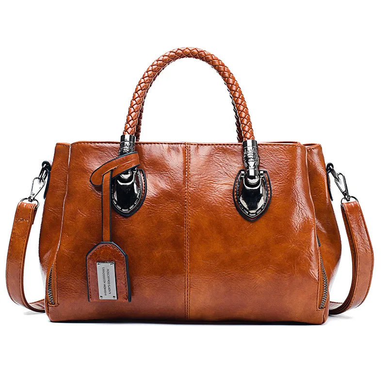 Bolso de piel Cassandra de Vega Madrid, bolso versátil con asa superior y compartimentos, en color negro.
