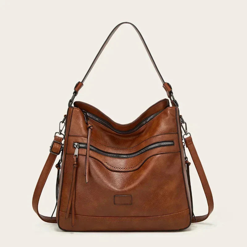 Bolso de hombro vintage de piel Selena de Vega Madrid, detalle de cuero en tono clásico y asa ajustable.