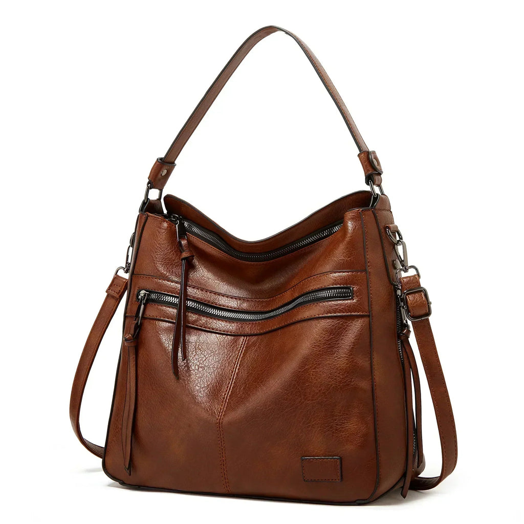 Bolso de hombro de piel Selena de Vega Madrid, vintage y elegante, con detalles en cuero en color marrón y asa ajustable.