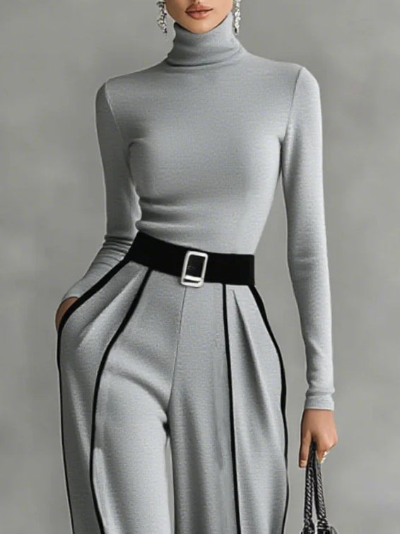 Conjunto elegante Inés de Vega Madrid en gris con detalles en contraste, diseño sofisticado y moderno para ocasiones especiales.