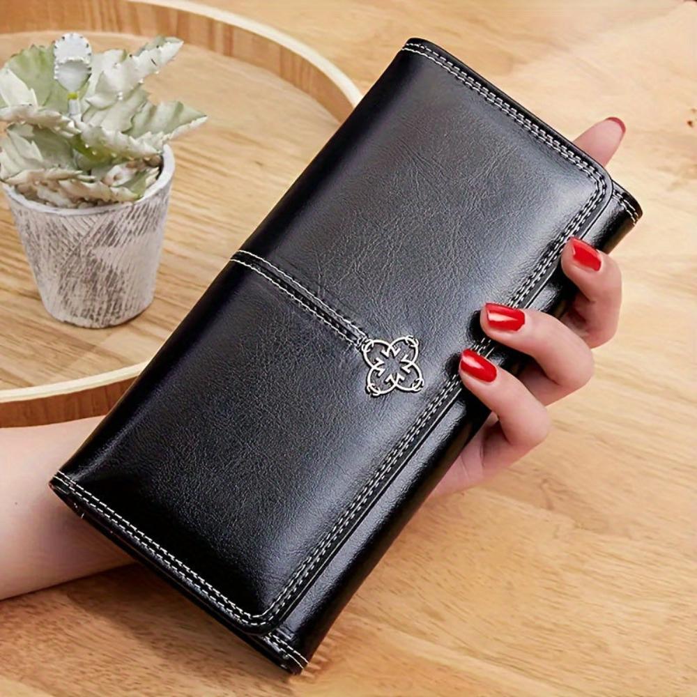 Cartera larga de piel Nicole de Vega Madrid, diseño elegante y acabado en cuero, con múltiples compartimentos para tarjetas y dinero.