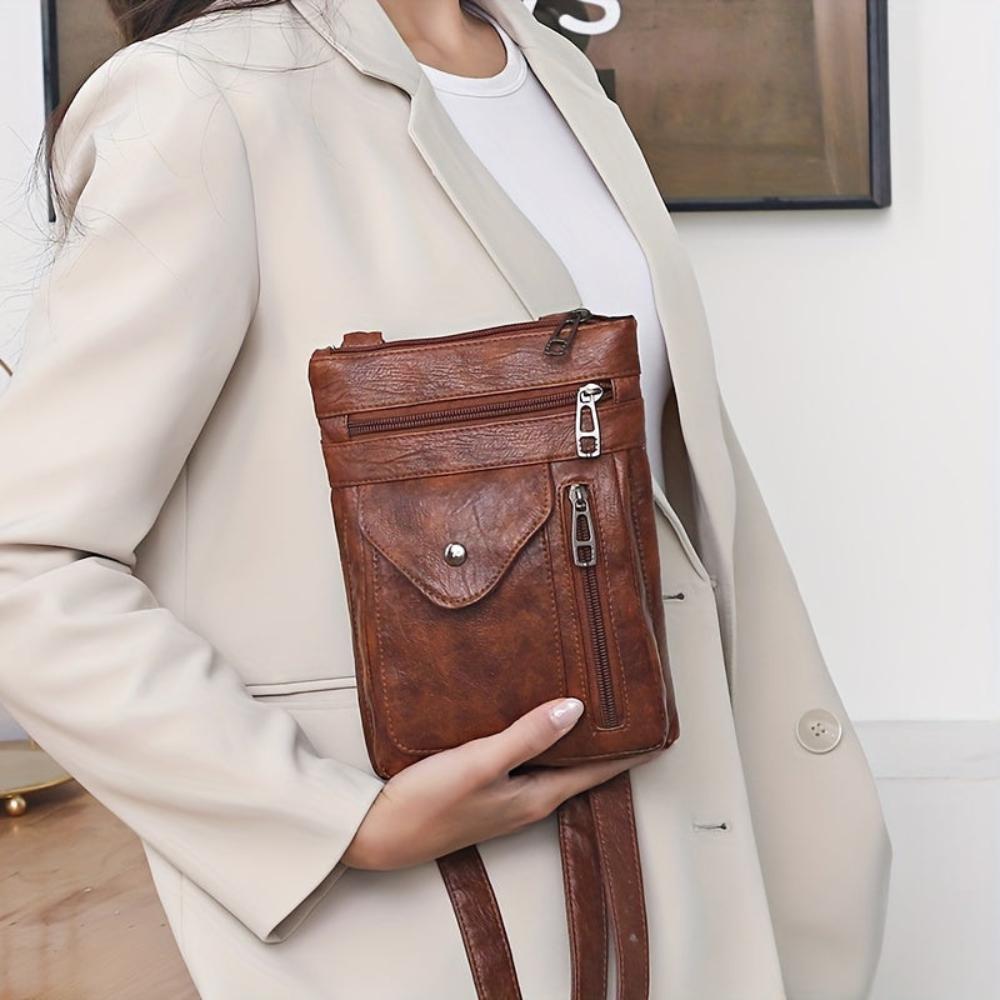 Bolso bandolera de piel Danielle de Vega Madrid con correa ajustable y acabado elegante en color neutro.