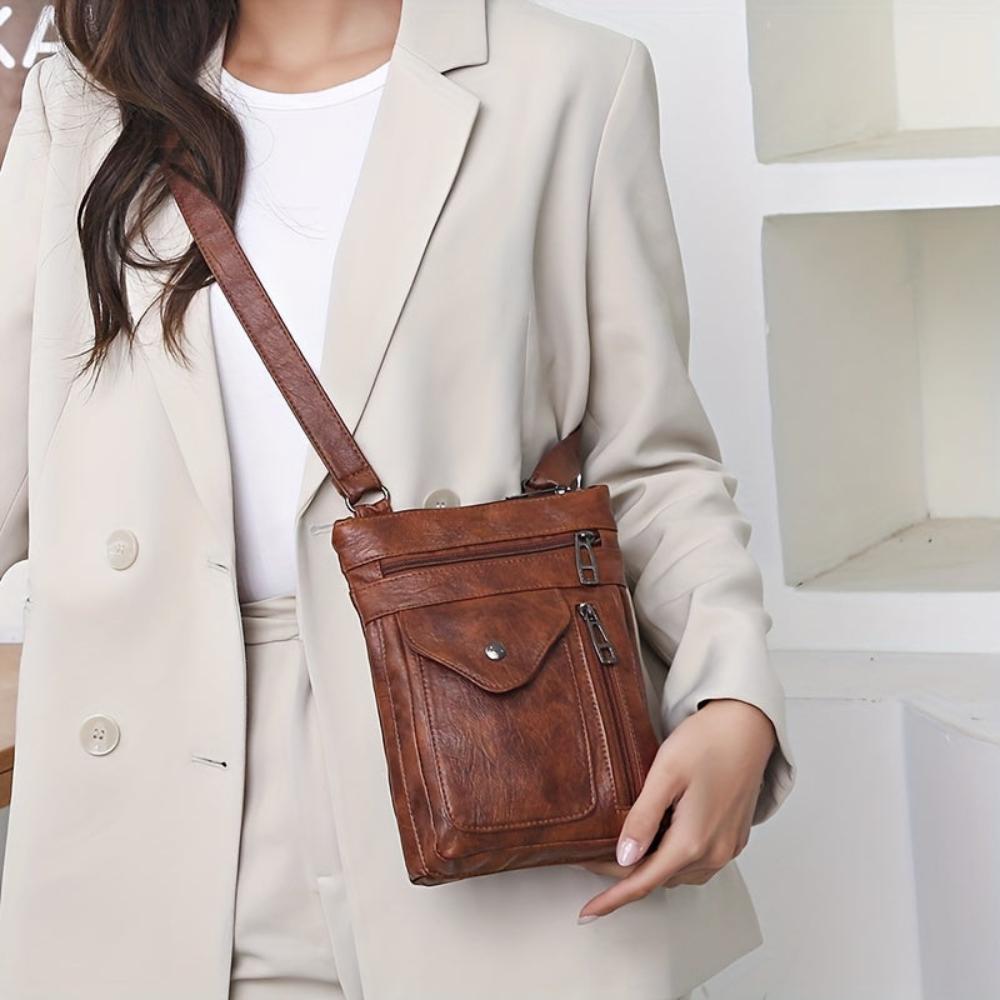 Bolso bandolera de piel Danielle de Vega Madrid, con tirantes ajustables y acabado elegante en tonos marrón.