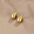 Pendientes colgantes Ame Gold de Vega Madrid con diseño en forma de lágrima de oro brillante.