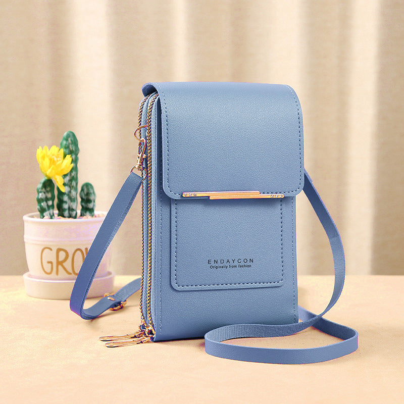 Bolso bandolera compacto Sandra de Vega Madrid, diseño minimalista en color neutro, con correa ajustable y acabado elegante.
